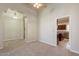 Open-concept living room with neutral walls, carpeting, arches, and a view into the kitchen at 5345 E Mclellan Rd # 83, Mesa, AZ 85205