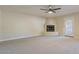 Cozy living room featuring plush carpeting, a corner fireplace, and access to the outdoors at 5345 E Mclellan Rd # 83, Mesa, AZ 85205