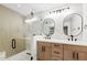 Modern bathroom with double sinks, light wood cabinetry, glass shower door at 5927 E Edgemont Ave, Scottsdale, AZ 85257