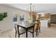 Dining room with modern chandelier and sliding doors with pool view at 5927 E Edgemont Ave, Scottsdale, AZ 85257