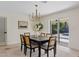 Dining room with modern chandelier and sliding doors with pool view at 5927 E Edgemont Ave, Scottsdale, AZ 85257