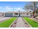 Beautiful single-story home featuring desert landscaping, brick walkway, and modern garage door at 5927 E Edgemont Ave, Scottsdale, AZ 85257