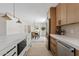 Open kitchen and dining area featuring stainless steel appliances and modern cabinetry at 5927 E Edgemont Ave, Scottsdale, AZ 85257