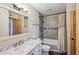 Updated bathroom with a marble vanity, tiled shower, and modern fixtures at 6169 N Granite Reef Rd, Scottsdale, AZ 85250