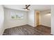 Bright bedroom with a ceiling fan, window with shutters and wood-look flooring at 6169 N Granite Reef Rd, Scottsdale, AZ 85250