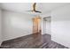 Bright bedroom features modern ceiling fan, light walls, closet, and wood-look flooring at 6169 N Granite Reef Rd, Scottsdale, AZ 85250