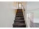 Staircase with hardwood steps and white walls, leading to the upper level at 6169 N Granite Reef Rd, Scottsdale, AZ 85250