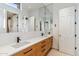 Bright bathroom with a double sink vanity, large mirrors, and modern black fixtures at 6508 N 28Th St, Phoenix, AZ 85016