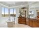 Bright bathroom featuring a garden tub, large windows, and stylish vanities at 6508 N 28Th St, Phoenix, AZ 85016