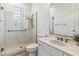 Accessible bathroom featuring a glass shower with seating and safety bar, a vanity, and commode at 6508 N 28Th St, Phoenix, AZ 85016