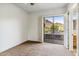 Bedroom leading to a patio with mountain view featuring open shutters and metal patio furniture at 6508 N 28Th St, Phoenix, AZ 85016