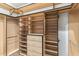 Organized walk-in closet featuring shelves, drawers, and hanging rods for ample storage at 6508 N 28Th St, Phoenix, AZ 85016