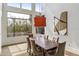 Dining room with a large window overlooking a swimming pool, complemented by stylish lighting and modern art at 6508 N 28Th St, Phoenix, AZ 85016