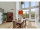 Dining room with a view of the pool, high ceilings, and a sleek wooden cabinet, creating an elegant dining experience at 6508 N 28Th St, Phoenix, AZ 85016