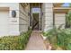 Elegant entryway with a chandelier view, framed by lush landscaping and a decorative urn, enhancing curb appeal at 6508 N 28Th St, Phoenix, AZ 85016