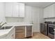 Well-organized laundry room features a stainless steel washer and dryer and white cabinets at 6508 N 28Th St, Phoenix, AZ 85016