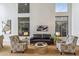 Comfortable living room with modern decor, high ceilings, and multiple windows, creating a bright and open living space at 6508 N 28Th St, Phoenix, AZ 85016