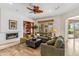 Cozy living room with a fireplace, ceiling fan, and comfortable green couches at 6508 N 28Th St, Phoenix, AZ 85016