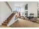 Spacious living room featuring high ceilings, a staircase, and large windows, creating a bright and airy atmosphere at 6508 N 28Th St, Phoenix, AZ 85016