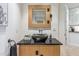 Contemporary powder room boasts a black vessel sink, wooden vanity, and modern fixtures at 6508 N 28Th St, Phoenix, AZ 85016