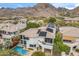 View of home with a covered balcony, mountain views and swimming pool at 6508 N 28Th St, Phoenix, AZ 85016