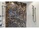 Modern bathroom shower with marble tile and sleek chrome fixtures at 6508 N 28Th St, Phoenix, AZ 85016