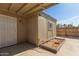 The backyard features a covered patio, storage, and a wood fence at 6711 W Osborn Rd # 127, Phoenix, AZ 85033