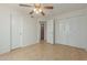 Comfortable bedroom featuring tile flooring, a ceiling fan, and closet storage space at 6711 W Osborn Rd # 127, Phoenix, AZ 85033