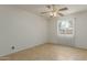 Cozy bedroom with tile flooring, a ceiling fan, and a window that offers plenty of natural light at 6711 W Osborn Rd # 127, Phoenix, AZ 85033