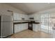 Bright kitchen with white cabinetry, black appliances, tile floors, and ample counter space for meal preparation at 6711 W Osborn Rd # 127, Phoenix, AZ 85033