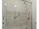 Updated shower features glass doors, handrails, and shower seat at 6711 W Osborn Rd # 127, Phoenix, AZ 85033