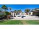 Enjoy the desert landscape of this home's backyard that features an outdoor kitchen and pool at 737 E Boston St, Gilbert, AZ 85295