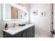 Modern bathroom featuring a double sink vanity, a large illuminated mirror, and stylish wall art at 737 E Boston St, Gilbert, AZ 85295