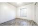 Bright bedroom featuring neutral walls, wood-look flooring, and ample natural light through a window with blinds at 737 E Boston St, Gilbert, AZ 85295