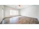 This spacious bedroom offers wood-look tile flooring, a ceiling fan, and ample natural light through large windows at 737 E Boston St, Gilbert, AZ 85295