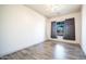 Bright bedroom with neutral walls, wood-look flooring, and large window covered with dark curtains at 737 E Boston St, Gilbert, AZ 85295