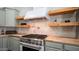 This kitchen features butcher block counters, modern cabinets, and a stainless steel range with copper accents at 737 E Boston St, Gilbert, AZ 85295