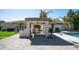 This outdoor kitchen features a built-in grill, sink, ceiling fan, and ample counter space at 737 E Boston St, Gilbert, AZ 85295