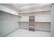 Organized walk-in closet with custom shelving and rods, offering plenty of storage space for clothes and accessories at 737 E Boston St, Gilbert, AZ 85295