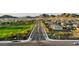 A bird's eye view of the neighborhood and green spaces, surrounded by mountains at 7400 W Quail Track Dr, Peoria, AZ 85383