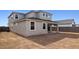 A view of the backyard, showing stucco exterior walls and the covered patio at 7400 W Quail Track Dr, Peoria, AZ 85383