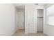 Bedroom featuring carpet, closet, baseboards, and an adjacent door to another room at 7400 W Quail Track Dr, Peoria, AZ 85383