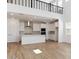 An open concept view of the kitchen, dining, and living area with wood-look flooring and tall ceilings at 7400 W Quail Track Dr, Peoria, AZ 85383