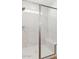 Modern walk-in shower featuring a glass enclosure, bench seat and tiled walls at 7400 W Quail Track Dr, Peoria, AZ 85383