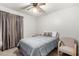 Bedroom featuring simple decor, ceiling fan, bed with light blue bedding, and beige walls at 76 N 133Rd St, Chandler, AZ 85225