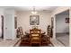 Formal dining room with wood table and chair set centered on a decorative area rug with a chandelier at 76 N 133Rd St, Chandler, AZ 85225