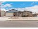 Charming single-story home featuring a brick facade, well-maintained landscaping, and a two-car garage at 76 N 133Rd St, Chandler, AZ 85225