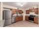 Traditional kitchen featuring wood cabinets, stainless steel appliances, and neutral granite countertops at 76 N 133Rd St, Chandler, AZ 85225