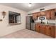 Kitchen with stainless steel appliances, wooden cabinetry, granite countertops, and view to other room at 76 N 133Rd St, Chandler, AZ 85225