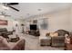 Comfortable living room with plush seating, ceiling fans, and ample natural light from the windows at 76 N 133Rd St, Chandler, AZ 85225